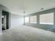 Large bedroom with three windows and a ceiling fan at 10105 Prattville Ave, Las Vegas, NV 89148