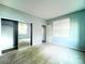 Bedroom featuring a large window, mirrored closet doors, and carpet flooring at 10105 Prattville Ave, Las Vegas, NV 89148