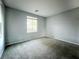 Neutral bedroom featuring a large window, carpet flooring, and ample space for customization at 10105 Prattville Ave, Las Vegas, NV 89148