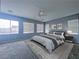 Bedroom featuring a large bed, ceiling fan, and three windows at 10105 Prattville Ave, Las Vegas, NV 89148