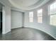 Formal dining room featuring a curved wall with large windows and wood floors at 10105 Prattville Ave, Las Vegas, NV 89148