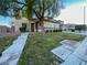 Manicured front yard with lush lawn and mature landscaping around a two-story home at 10105 Prattville Ave, Las Vegas, NV 89148