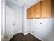 Laundry room with wood cabinets, neutral paint, and laminate flooring at 10105 Prattville Ave, Las Vegas, NV 89148