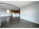 Open living area featuring archways, dark laminate wood flooring and access to kitchen at 10105 Prattville Ave, Las Vegas, NV 89148