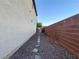 Narrow side yard with stone pavers and gravel leading to backyard access at 10105 Prattville Ave, Las Vegas, NV 89148