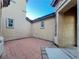 Small side yard between homes with concrete and brick pavers at 10105 Prattville Ave, Las Vegas, NV 89148