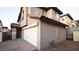 Exterior view showcasing the home's stucco facade, two-car garage, and tile roof at 10596 Corte Sierra St, Las Vegas, NV 89183