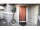 Inviting front door with a decorative potted plant and circular welcome mat at 10596 Corte Sierra St, Las Vegas, NV 89183