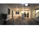 Spacious living room flows into the kitchen, complete with modern flooring and ceiling fan at 10596 Corte Sierra St, Las Vegas, NV 89183