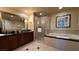 Spacious bathroom with double vanity, a walk-in shower, soaking tub, and tile flooring at 135 E Harmon Ave # 307, Las Vegas, NV 89109