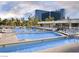 Expansive outdoor swimming pool with clear blue water and comfortable lounge chairs at 135 E Harmon Ave # 307, Las Vegas, NV 89109