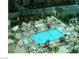 Aerial view of a pool and lounge area surrounded by palm trees and buildings at 135 E Harmon Ave # 307, Las Vegas, NV 89109