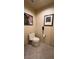 Small toilet room with a standard toilet, and tiled floor and walls, lit by overhead lights at 135 E Harmon Ave # 307, Las Vegas, NV 89109