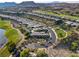 Stunning aerial view of a luxury home in a golf community with mountain views at 15 Reflection Bay Dr, Henderson, NV 89011