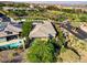 Beautiful aerial view of a home with a pool, spa, and lush landscaping near a golf course at 15 Reflection Bay Dr, Henderson, NV 89011