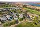 Scenic aerial view of a home in a golf community near a lake with lush landscaping at 15 Reflection Bay Dr, Henderson, NV 89011