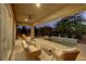 Outdoor seating with a pool and beautiful landscaping under a covered patio at 15 Reflection Bay Dr, Henderson, NV 89011