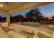 Backyard with plush seating under a covered patio looking out to a pool at 15 Reflection Bay Dr, Henderson, NV 89011