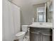 Bathroom featuring white shower curtain, toilet, vanity with granite countertop, and large mirror at 15 Reflection Bay Dr, Henderson, NV 89011