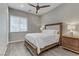 Comfortable bedroom with wood-look floors, ceiling fan and a large window at 15 Reflection Bay Dr, Henderson, NV 89011