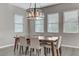 Bright dining room features modern chandelier, neutral walls, and multiple windows at 15 Reflection Bay Dr, Henderson, NV 89011