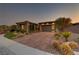 Beautiful single-story home with stone accents, brick driveway, and well-manicured landscaping at 15 Reflection Bay Dr, Henderson, NV 89011