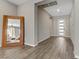 Entryway with wood-look floors, large mirror, and white front door at 15 Reflection Bay Dr, Henderson, NV 89011