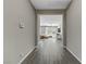 Hallway with light gray walls and wood-look floors leading to the living room at 15 Reflection Bay Dr, Henderson, NV 89011