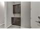 Hallway built-in with dark wood cabinets and drawers, offering extra storage space, next to a white door at 15 Reflection Bay Dr, Henderson, NV 89011