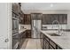 Close-up of kitchen with stainless steel appliances, granite counters, and dark wood cabinets at 15 Reflection Bay Dr, Henderson, NV 89011