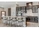 Kitchen area with granite countertop island, stainless steel appliances, and dark wood cabinetry at 15 Reflection Bay Dr, Henderson, NV 89011