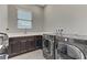 Well-equipped laundry room featuring modern washer and dryer and laminate countertops at 15 Reflection Bay Dr, Henderson, NV 89011