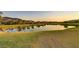 Beautiful pond reflecting the surrounding golf course and sunset sky at 15 Reflection Bay Dr, Henderson, NV 89011