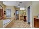 Spacious bathroom with a bathtub, vanity, and natural light at 1883 Nature Park Dr, North Las Vegas, NV 89084