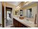 Bathroom with double sink vanity, tile countertops, and access to additional rooms at 1883 Nature Park Dr, North Las Vegas, NV 89084