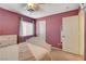 Bedroom featuring neutral carpet, window with blinds and curtains, and a white door at 1883 Nature Park Dr, North Las Vegas, NV 89084