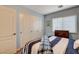 Bedroom with a nautical theme, a dresser near the window and closet at 1883 Nature Park Dr, North Las Vegas, NV 89084