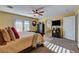 Bright bedroom featuring a ceiling fan, a bed, and access to the bathroom at 1883 Nature Park Dr, North Las Vegas, NV 89084