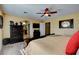 Well-lit bedroom with a ceiling fan and access to the bathroom at 1883 Nature Park Dr, North Las Vegas, NV 89084