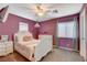 Bright bedroom featuring stylish décor, a comfortable bed, and natural light from large windows at 1883 Nature Park Dr, North Las Vegas, NV 89084