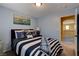 Nautical-themed bedroom featuring a comfortable bed, soft blue walls, and nice decor at 1883 Nature Park Dr, North Las Vegas, NV 89084