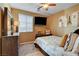 Cozy bedroom featuring warm tones, ceiling fan and a mounted flat screen television at 1883 Nature Park Dr, North Las Vegas, NV 89084