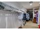 Walk-in closet with abundant storage, multiple hanging racks, and neatly arranged shelving at 1883 Nature Park Dr, North Las Vegas, NV 89084