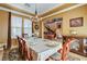 A cozy dining area with a wooden table set for dinner and views of the staircase at 1883 Nature Park Dr, North Las Vegas, NV 89084