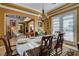 Well-lit dining area featuring chandelier, white tablecloth, and a view to other rooms at 1883 Nature Park Dr, North Las Vegas, NV 89084