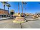 Gated community entrance with lush landscaping and mountain views in the background at 1883 Nature Park Dr, North Las Vegas, NV 89084