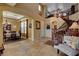 Spacious foyer showcasing natural light, a winding staircase and a dining room at 1883 Nature Park Dr, North Las Vegas, NV 89084