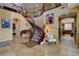 Elegant foyer featuring a winding staircase, chandelier and a ceramic tile floor at 1883 Nature Park Dr, North Las Vegas, NV 89084