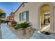 Close-up of desert landscaping and covered entryway with an arched design at front door at 1883 Nature Park Dr, North Las Vegas, NV 89084