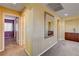 Hallway with neutral paint, carpeted floors, and view to rooms with doors and windows at 1883 Nature Park Dr, North Las Vegas, NV 89084